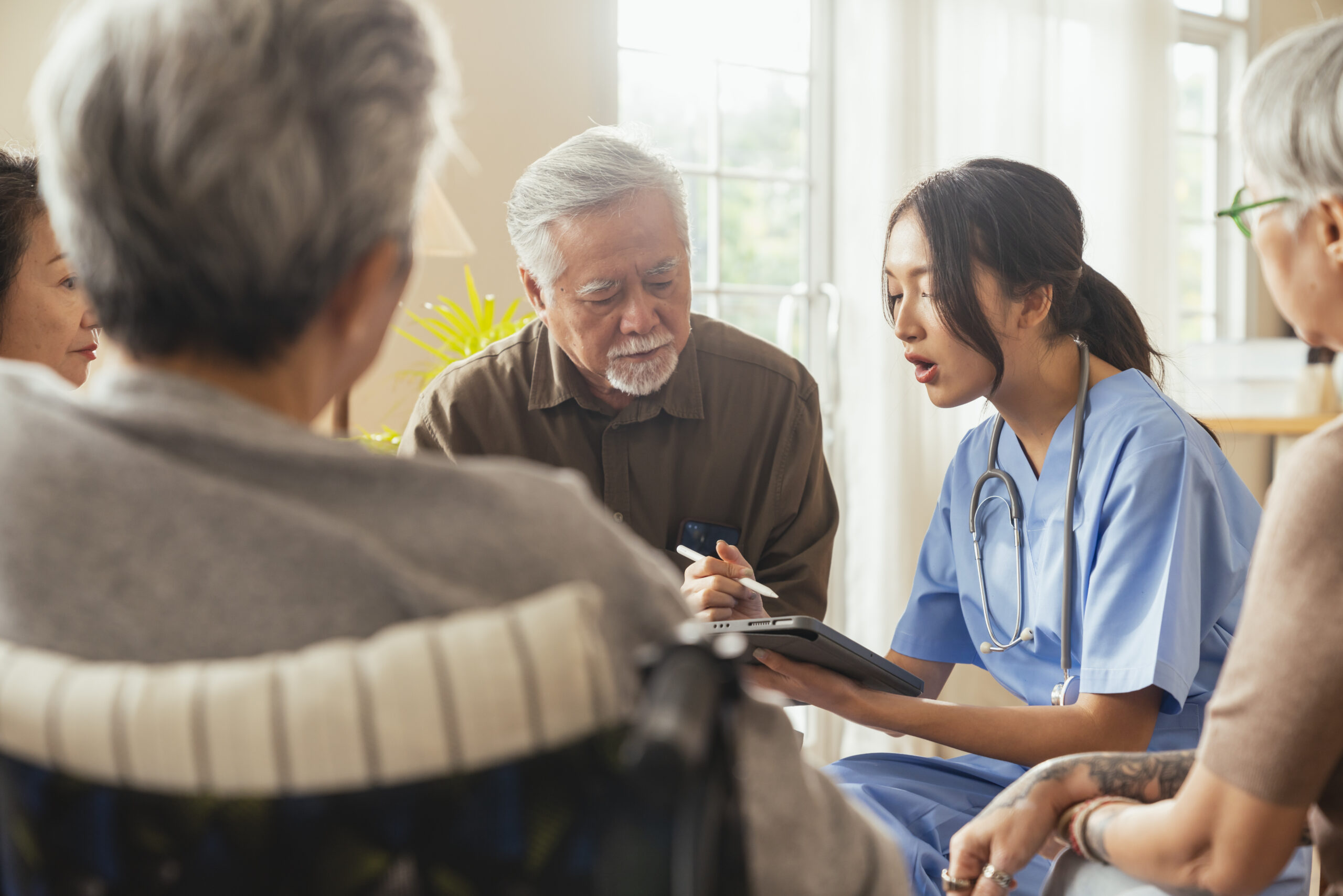 Happiness Cheerful Elderly Woman Men Talking With Female Caregiver Nurse Doctor Having Health Checking Consult Living Areacaretakers With Senior Couple Sitting Living Room Nursing Home(1) (1)